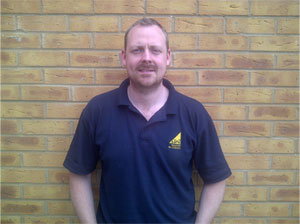 Andrew Sweedy in a navy work polo