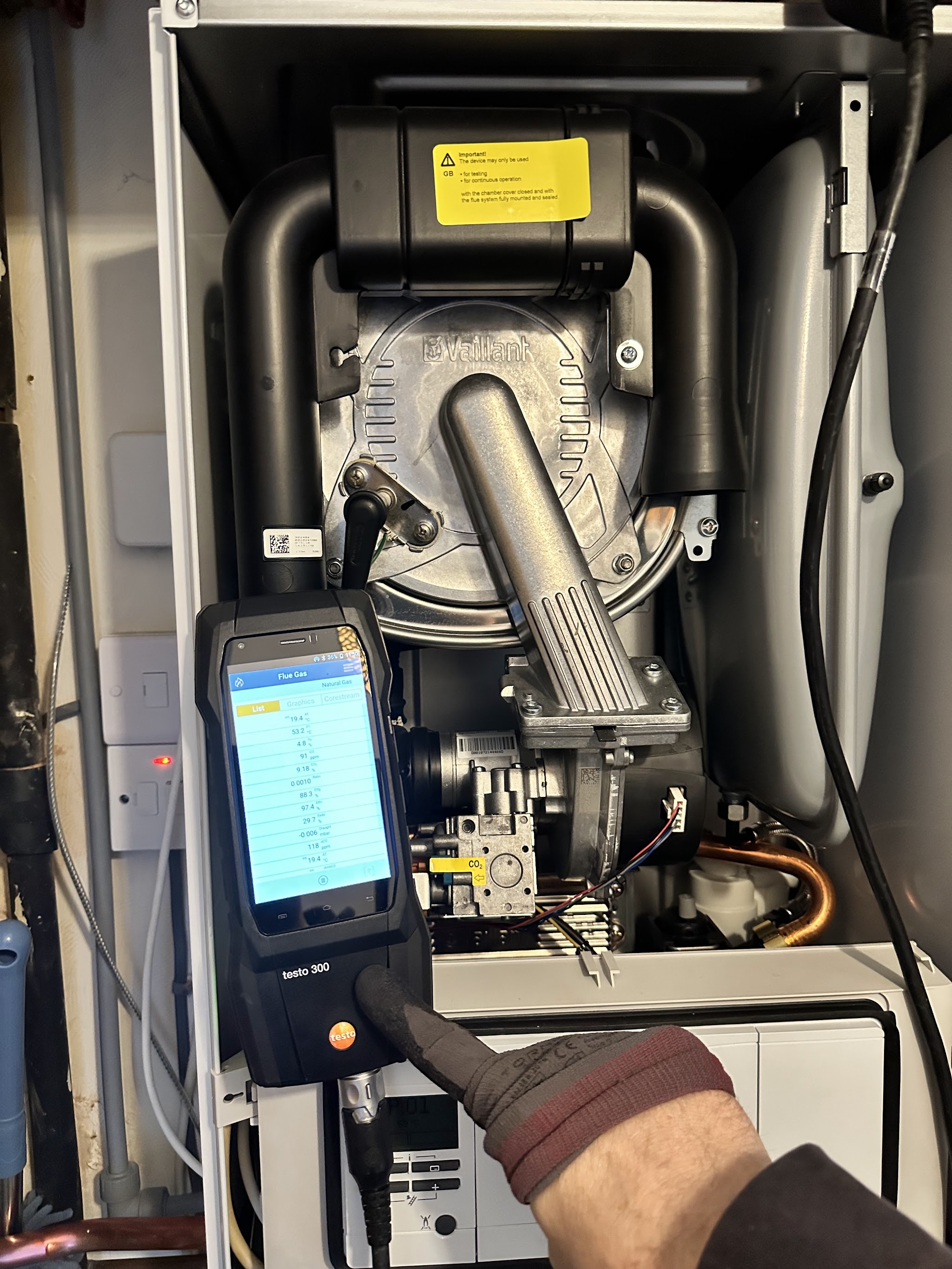 Testing an open boiler with a flue gas analyser during a service